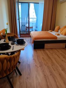 a hotel room with a bed and a table and chairs at One-room boutique at Sunrise All Suites in Obzor +52 photos