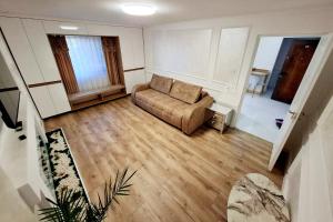 a living room with a couch and a chair at Dream ApartHotel in Turda