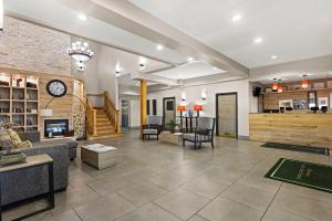 a living room with a couch and a fireplace at Country Inn & Suites by Radisson, Hinesville, GA in Hinesville