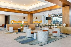 a lobby of a hotel with tables and chairs at Cambria Hotel Burbank Airport in Burbank