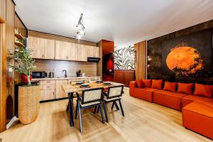 a living room with a red couch and a table at City Center Beachfront Apartments in Durrës