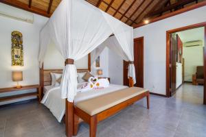 a bedroom with a bed with a canopy at Villa Alroda Antik - Peaceful 4BR Villa with Private Pool in Canggu in Dalung