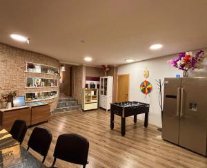 a living room with a table and a refrigerator at Anna's guesthouse in Riga