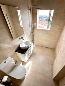 a bathroom with a toilet and a sink at Limassol Marina Seaview Suite in Limassol