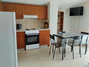a kitchen and dining room with a table and a refrigerator at Christina Apartment in Stavros