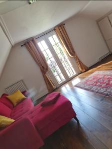 a living room with a couch and a large window at La petite maison normande in Honfleur
