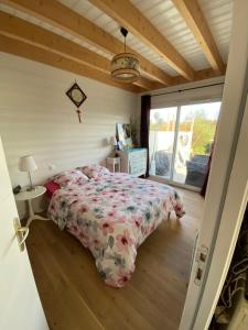 a bedroom with a bed in a room with a window at Villa Thorens in Morlaix