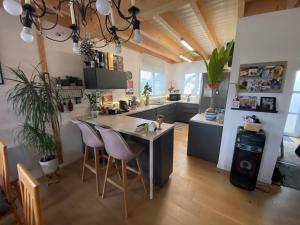 a kitchen with a table and chairs in a room at Villa Thorens in Morlaix