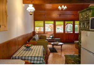 a living room with a couch and a table at Őrségi Tópart Vendégház in Hegyhátszentjakab +16 photos