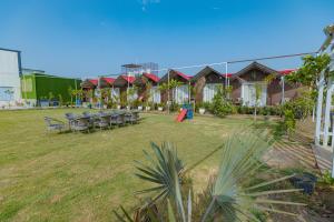 a resort with tables and chairs in a yard at Chandrika Green Resort in Vrindāvan