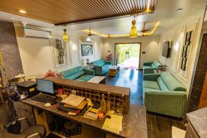 a living room with a couch and a table at Chandrika Green Resort in Vrindāvan +74 photos