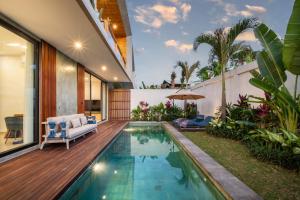 a swimming pool in the backyard of a house at Sunny Village Berawa in Canggu