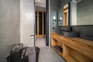 a bathroom with a sink and a mirror at Sunny Village Berawa in Canggu