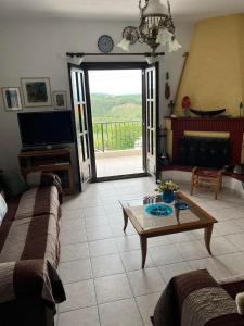 a living room with a couch and a coffee table at Villa Nefeli in Ayios Nikolaos Sithonia