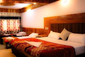a hotel room with two beds in a room at Laughter Love Live in Kotla