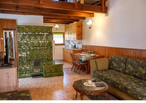 a living room with a couch and a table at Őrségi Tópart Vendégház in Hegyhátszentjakab