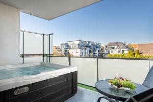 a balcony with a hot tub and a table at Onyx Luxury in Sárvár