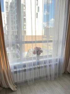 a teddy bear sitting on a window sill at Sat City block A in Astana +2 photos