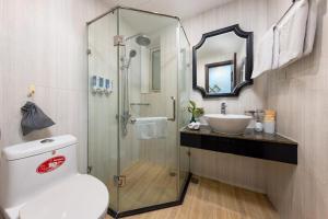 a bathroom with a shower and a toilet and a sink at Golden Legend Boutique Hotel in Hanoi +50 photos