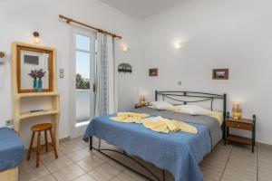 A bed or beds in a room at Apollon Rooms