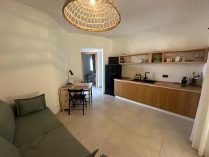 a living room and kitchen with a couch and a table at Agreen Country House in Olbia