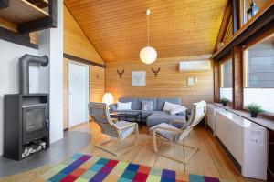a living room with a couch and a fireplace at Ferienhaus 10 Rechbergblick in Bernau im Schwarzwald