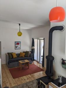 a living room with a black wood stove at Hikers' Corner - Planinarka in Kolašin