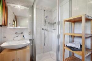 a bathroom with a shower and a sink and a shower at Ferienhaus 10 Rechbergblick in Bernau im Schwarzwald +22 photos