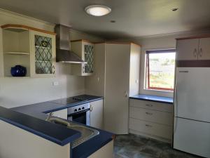 a kitchen with a sink and a stove top oven at 2 bedroom Apartment@Boutique Barn House Farm Stay in Timaru