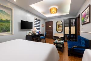 a hotel room with a bed and a desk at Golden Legend Boutique Hotel in Hanoi