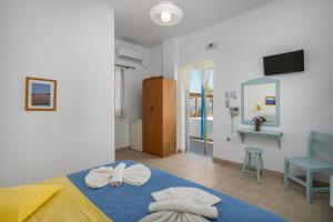 A bed or beds in a room at Apollon Rooms