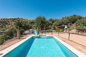 a swimming pool in a house with a fence at El Mirador del Abuelo in Málaga