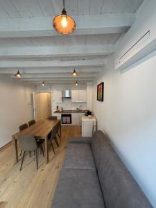 a living room with a couch and a table at Loggia Tre Piazze Apartments in Brescia +25 photos