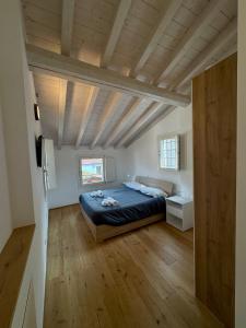 a bedroom with a bed and a wooden ceiling at Loggia Tre Piazze Apartments in Brescia