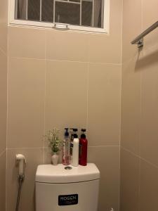 a bathroom with a toilet with a window above it at Mookda House Chinatown BKK near MRT Samyot in Khlong San +22 photos