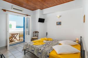 A bed or beds in a room at Apollon Rooms