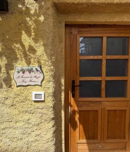 a door to a building with a sign next to it at La casina di mezzo - Tiny House in Camaiore