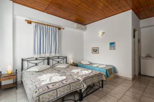 A bed or beds in a room at Apollon Rooms