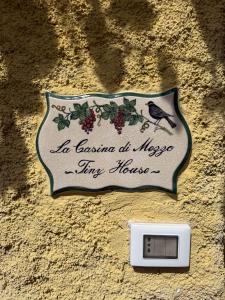 a sign on the side of a wall with a lightswitch at La casina di mezzo - Tiny House in Camaiore