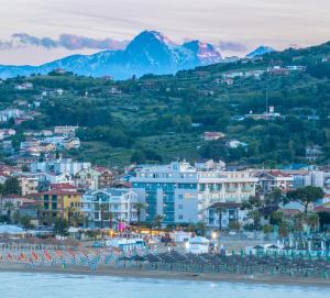 a view of a city with mountains in the background at Hotel Continental in Tortoreto Lido