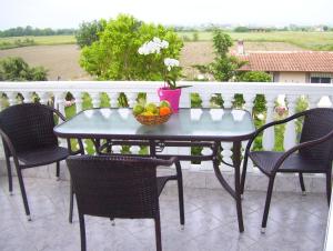 a table with a bowl of fruit on a balcony at Verginia Studios in Korinós