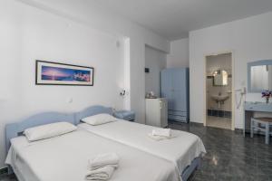 A bed or beds in a room at Apollon Rooms
