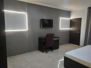 A television and/or entertainment centre at Skyrock Hotels Ogba