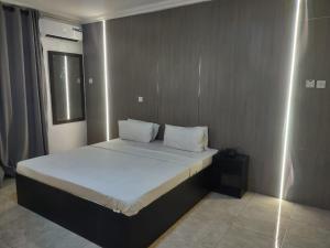 A bed or beds in a room at Skyrock Hotels Ogba