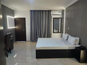 A bed or beds in a room at Skyrock Hotels Ogba