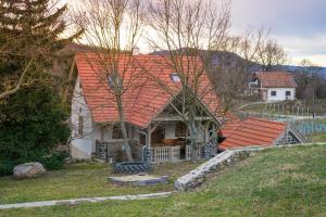 an old house with an orange roof on a hill at Hill & Chill in Káptalantóti
