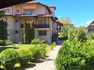 a house with a garden in front of it at Apartment Pirin in Bansko