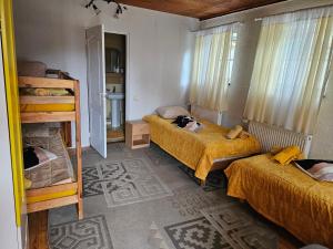 a room with two beds and a bunk bed at Upeslīči atpūtai in Jelgava +2 photos