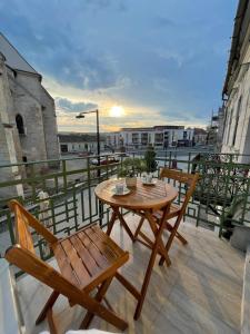 a wooden table and two chairs on a balcony at Central View Apartment in Turda