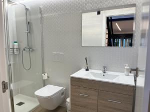 a bathroom with a toilet and a sink and a shower at Apartamentos Romero in Alicante +170 photos